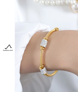 Detail of 18K gold-plated stainless steel snake chain bracelet with pavé rhinestone accents