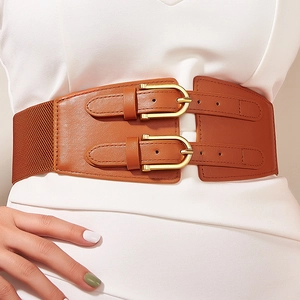 Detailed close-up of brown PU leather wide corset belt with double gold buckles on white dress