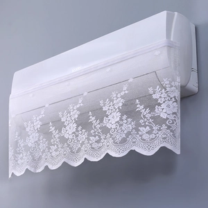 Detailed view of white lace air conditioner cover with elegant hollow floral pattern