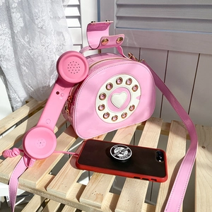 Creative retro telephone-shaped pink crossbody bag with dial details and handset handle