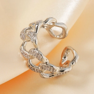 Adjustable silver chain ring with micro-pave zircons on a soft orange satin background