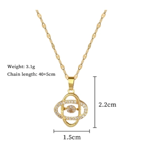 Macro view of gold-plated clover pendant with sparkling diamonds and champagne stone