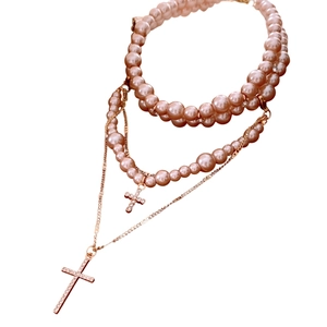 Multi-layer pearl necklace with sparkling rhinestone cross pendants and gold-tone chains