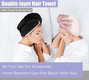 Close-up of double-layer hair towel and sleep cap in black towel and pink satin fabrics