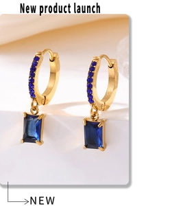 Close-up of square blue zircon earrings with gold plating and fine blue crystals
