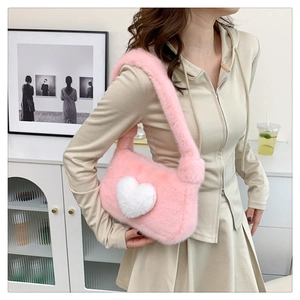 Detailed shot of a soft pink plush underarm bag with a white 3D heart pattern motif