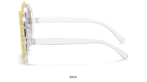 Side view of white daisy flower petals on transparent plastic frame of kids sunglasses