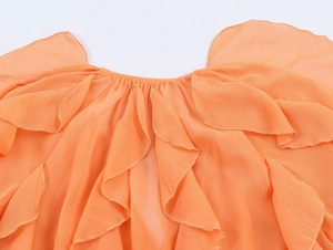 Detail of tiered orange chiffon ruffles and elastic neckline on a stylish women shirt