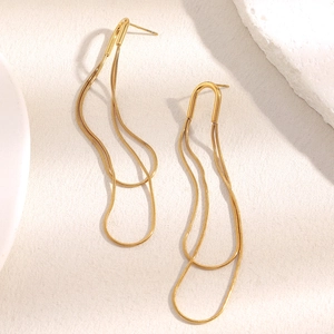 Close-up of double layered wave snake chain drop earrings in 18K gold plated steel