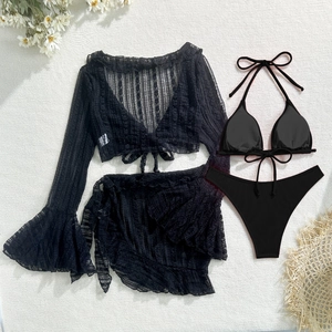 Flat lay of black four-piece lace bikini set with flared sleeve cover-up and rib bikini