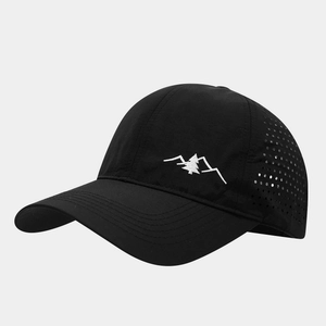 Detail of laser-cut ventilation holes and mountain embroidery on black quick-dry cap