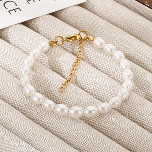 Detailed close-up of pearl bracelet with gold stainless steel lobster clasp and extender