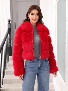Close-up of red short faux fur jacket with zipper and collar on a fashion model