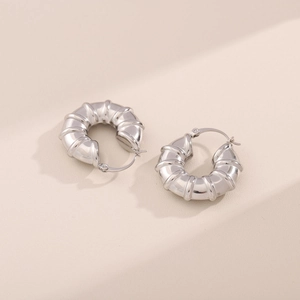 Minimalist silver stainless steel hollow hoop earrings with textured bamboo ribbing design