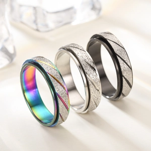 Matte rainbow silver and black spinning rings with diagonal grooved patterns for women