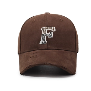 Brown baseball cap with embroidered letter F and distressed brim in vintage street style
