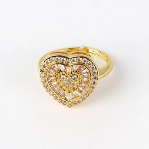 Detailed macro view of an open heart-shaped gold ring with micro-set shimmering crystals