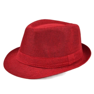Macro detail of red linen texture and matching woven band on a classic Panama fedora hat
