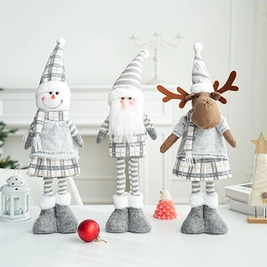 Three grey and white plush Christmas dolls including Santa, snowman and reindeer on table