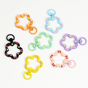 Colorful flower-shaped spring rings in multiple vibrant colors with decorative dot patterns
