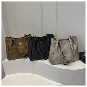 Detailed display of large tote bags in brown black and gray with suede texture chain straps