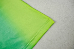 Detail of green and yellow gradient knit fabric with professional double needle stitching