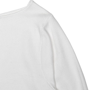 Detail showing the fine knit texture and shoulder seam of the white long sleeve dress