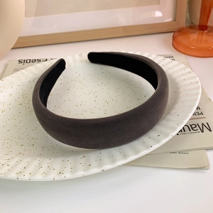 Detail of charcoal grey velvet padded headband on a vintage decorative tray