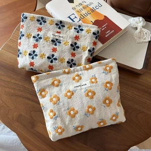 Detailed close-up of vintage floral embroidery on cotton-linen small cosmetic bags