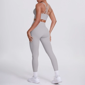 Détail d'un ensemble de yoga gris clair avec brassière à dos croisé et legging taille haute