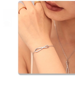 Close-up of infinity symbol bracelet with pavé cubic zirconia on model's wrist