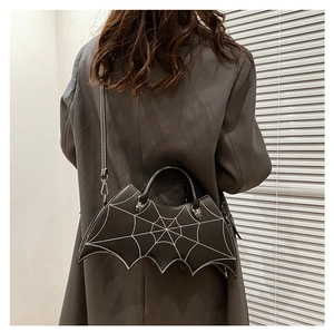 Detailed view of black bat shaped PU crossbody bag featuring spider web embroidery and silver spiders
