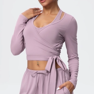 Detail of lavender wrap-around yoga top with waist tie and high-stretch fabric
