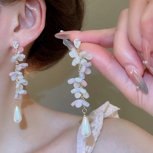 Detail of pink flower tassel earrings with teardrop pearls and shimmering cubic zirconia