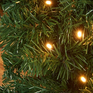 Lush green PVC Christmas garland featuring warm white LED lights for festive holiday decor