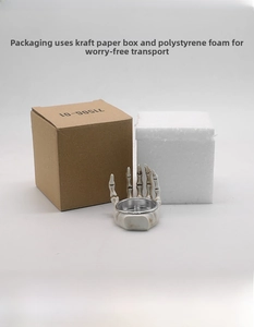 Detailed view of skull hand candle holder with metal liner and protective foam packaging