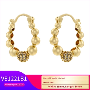 Detail of gold-plated brass hoop earrings featuring a micro-pave crystal ball accent