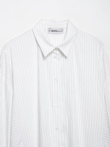 Detailed view of striped cotton shirt collar and label with European sizing information