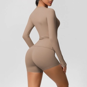 Detail of high-stretch camel yoga set showing slim-fit long sleeve top and lifting shorts