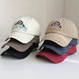 Detail showing stacked vintage baseball caps with Cowboy embroidery and distressed brim