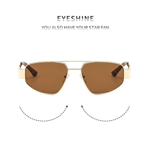 Detailed front view of gold double-bridge pilot sunglasses with brown lenses