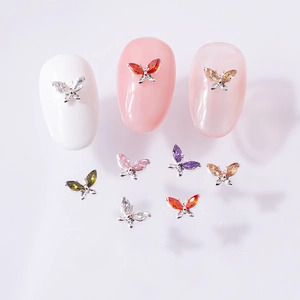Macro shot of 3D zircon butterfly nail charms in various colors on manicure tips