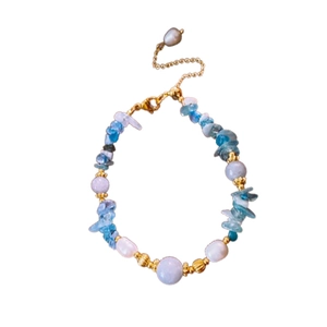 Handmade necklace with blue aquamarine stones, white pearls, and gold-plated clasp