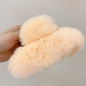 Close-up of fluffy peach faux fur hair claw clip showing soft texture and large size