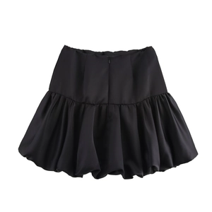 Detailed view of the invisible zipper and pleated waist on this black bubble mini skirt