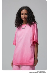 Detail of pink vintage wash cotton T-shirt showing fabric texture and oversized fit