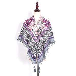 Detail of bohemian floral square scarf with fringe tassels on a mannequin