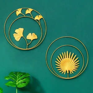 Golden iron wall decor set featuring ginkgo and palm leaves in round metal frames