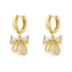 Detail of gold bow earrings featuring clear crystals and hanging white pearls