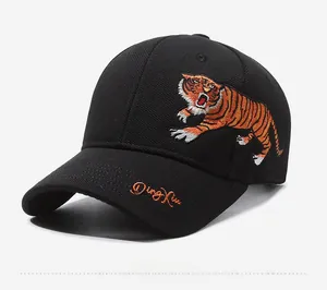 Close-up of intricate orange tiger embroidery and side stitching on black baseball cap